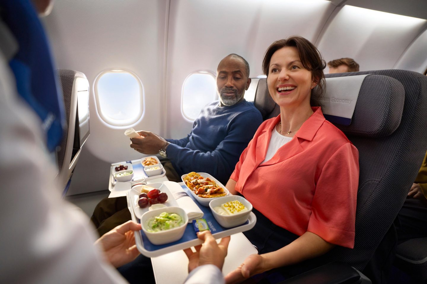 Intercontinental Premium Economy Class Two guests are served a meal in Premium Economy Class