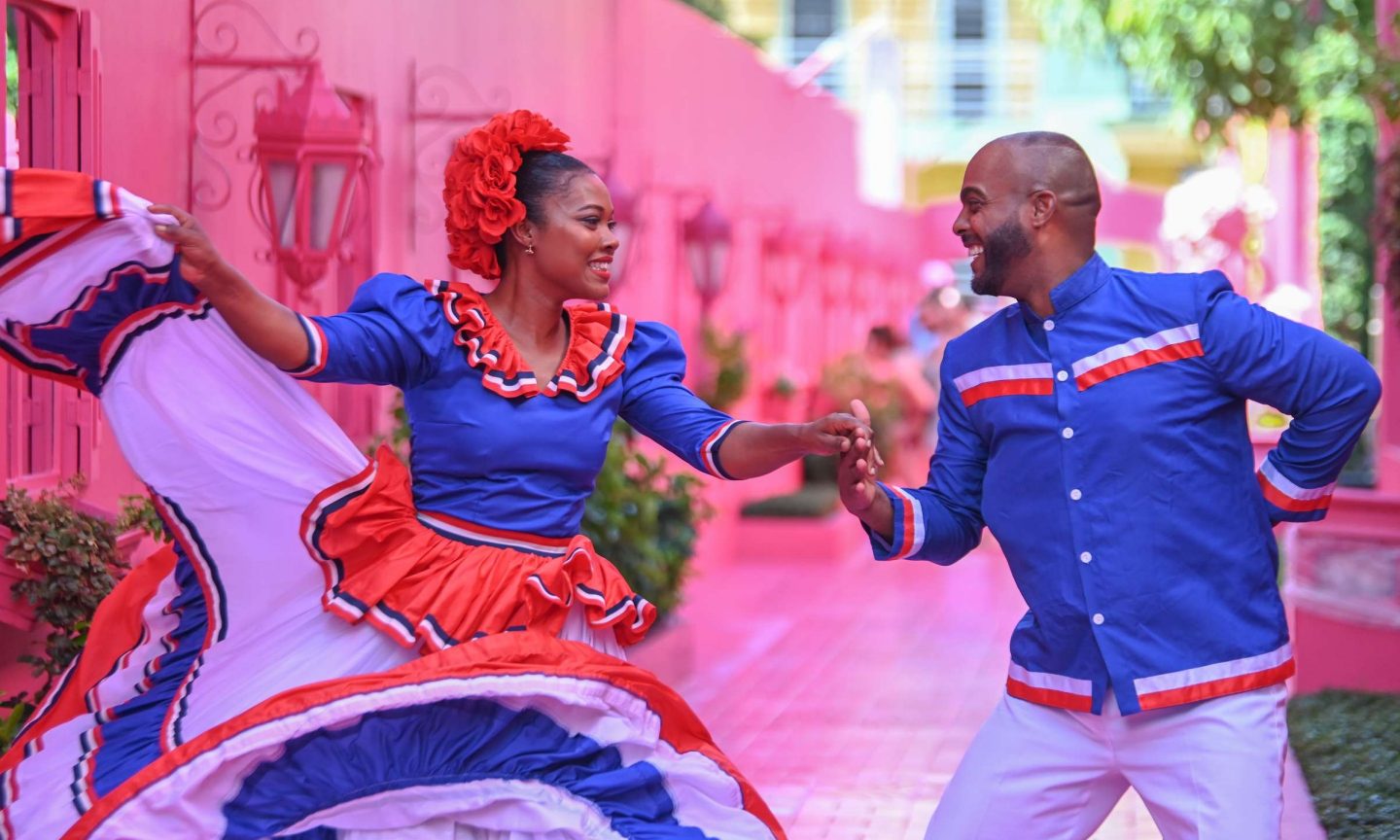 A woman and a man dancing merengue