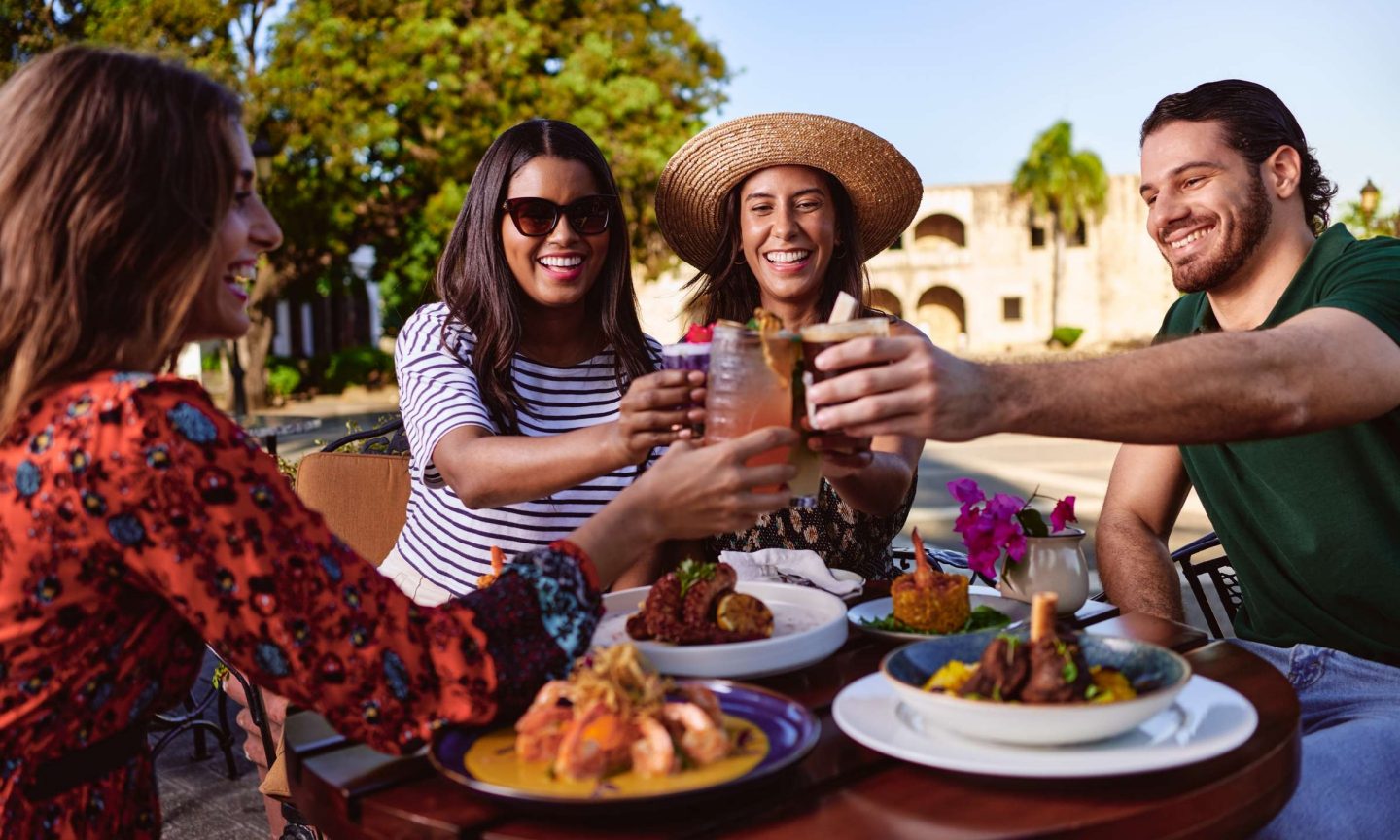 Four people eating typical local food in the Dominican Republic