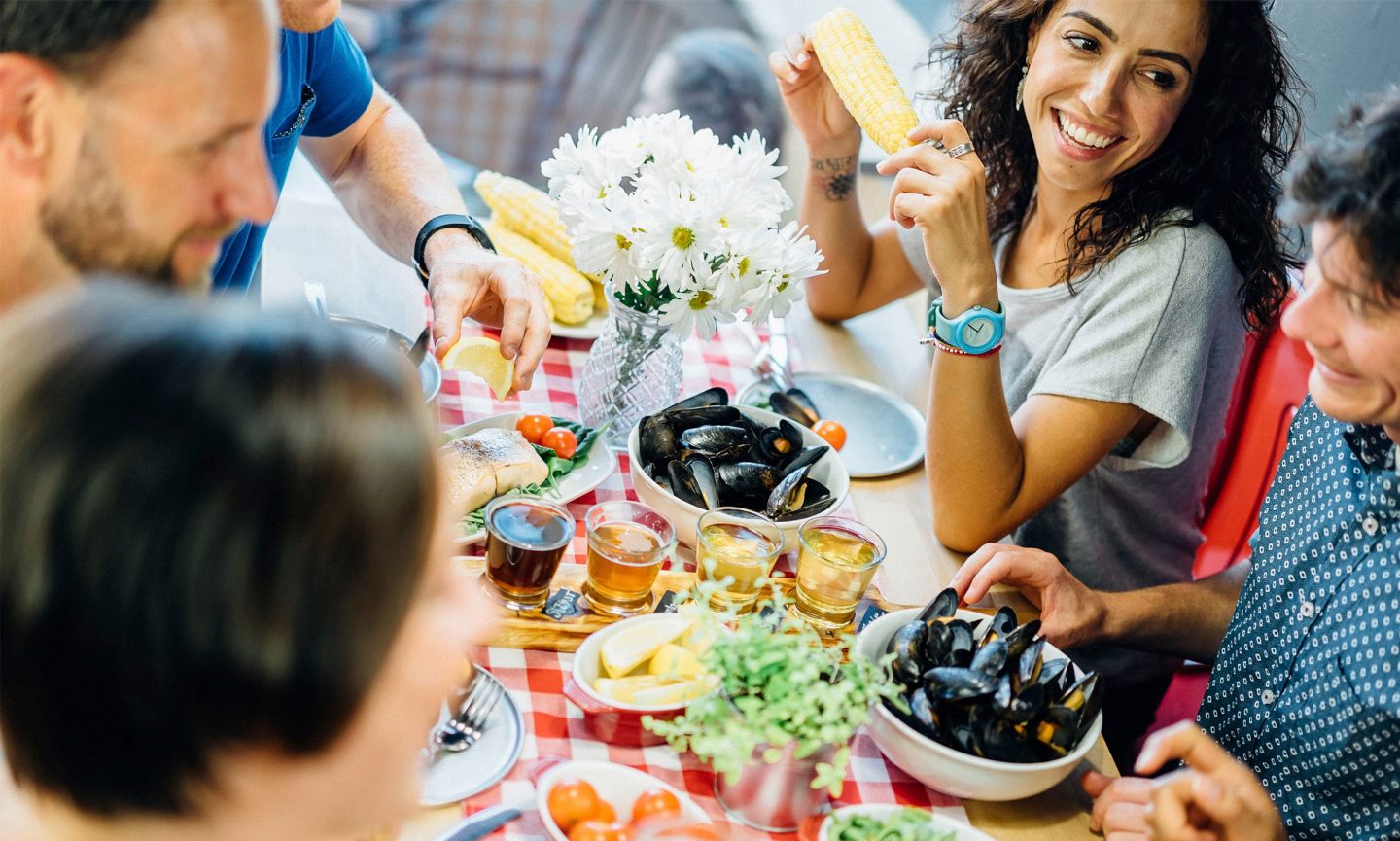 People sitting together at a table eating seafood