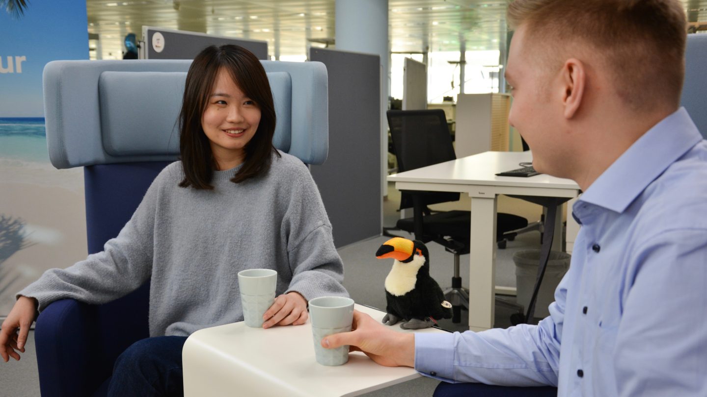 Two Discover Airlines employees drinking coffee together