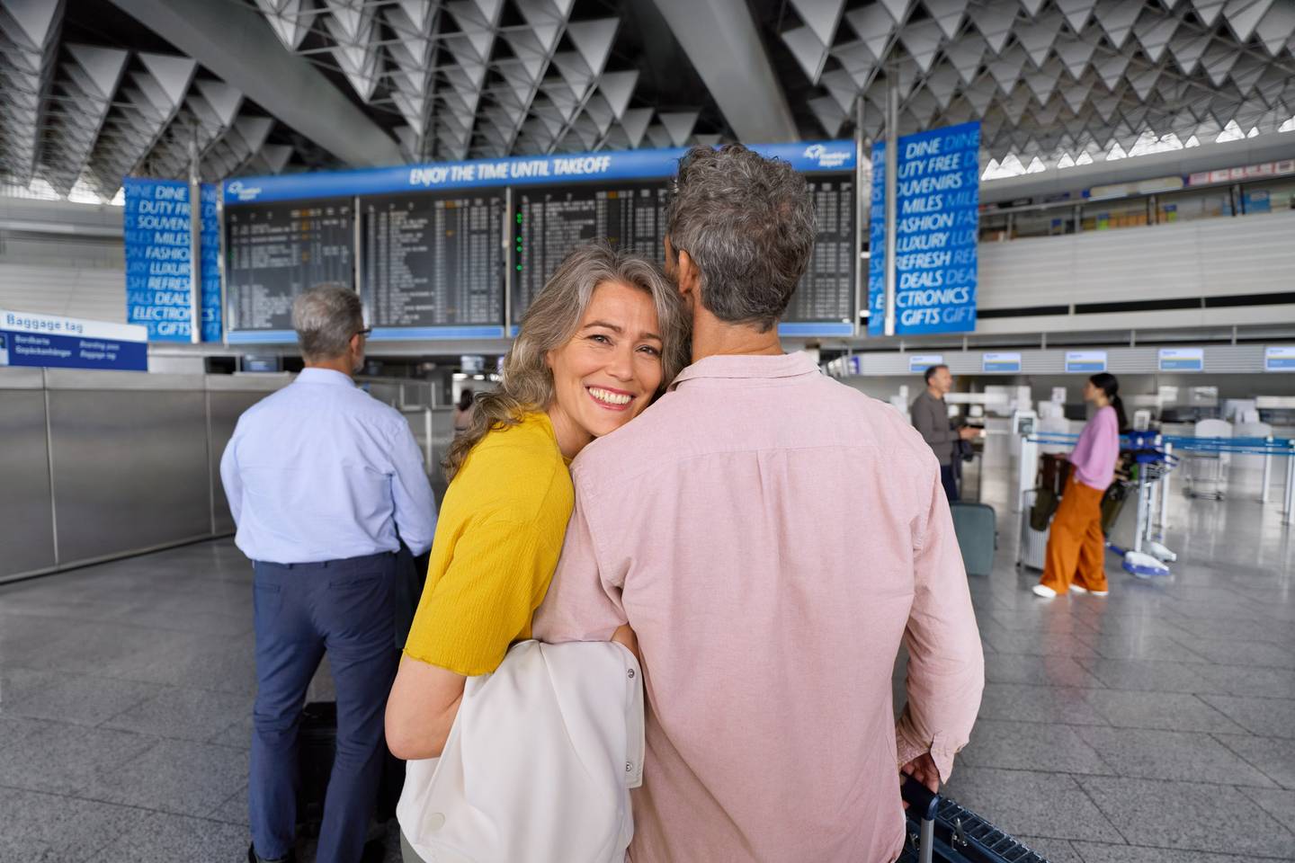 A couple standing in the departure hall at Frankfurt Airport