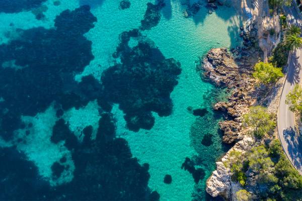 Vogelblick auf Bucht mit Korallenriffen auf Mallorca